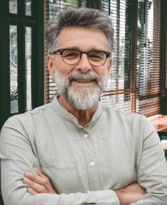 Middle-aged man smiling confidently after using MaxBoost supplement, sharing positive energy and vitality results